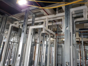 Domestic water piping insulated with fiberglass pip cover