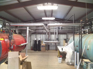 Steam pipe in the boiler room at a milk plant insulated with 2" mineral wool and finished with an aluminum jacket. Franklin insulation gallery