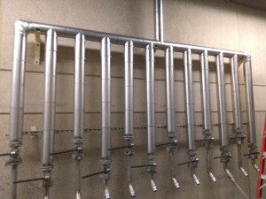 Process water distribution station covered in fiberglass pipe cover and aluminum jacketing. Franklin insulation gallery