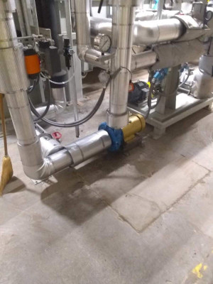 Chilled water pump and chilled water piping covered in fiberglass pipe cover and finished with aluminum jacketing. Franklin insulation gallery